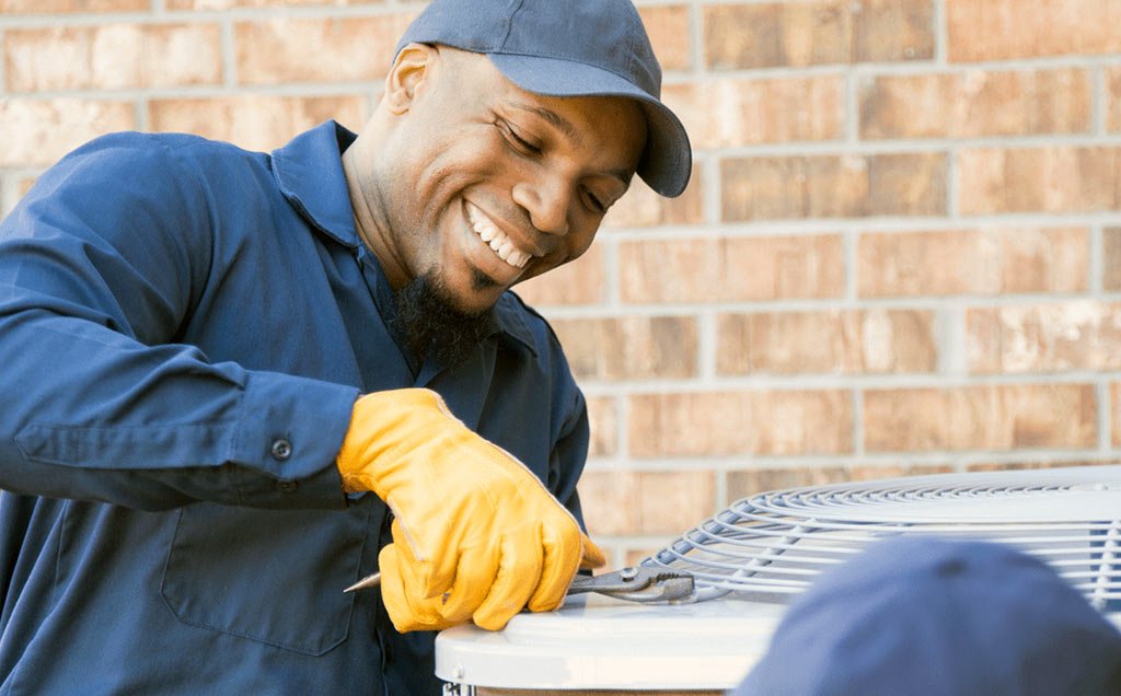 HVAC technician working on heat pump