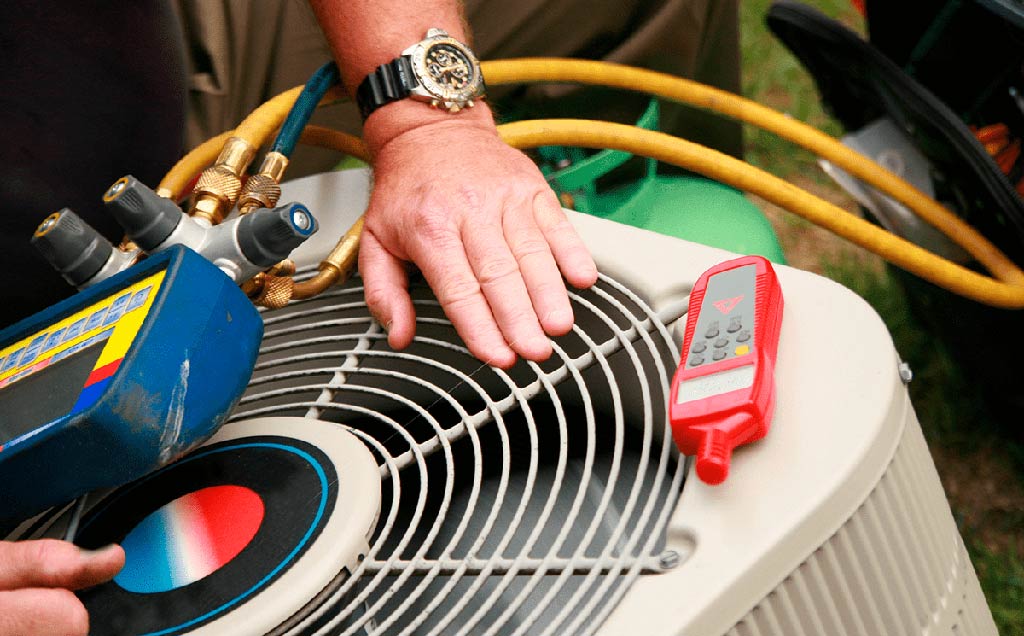 Service technician checking HVAC outside of home